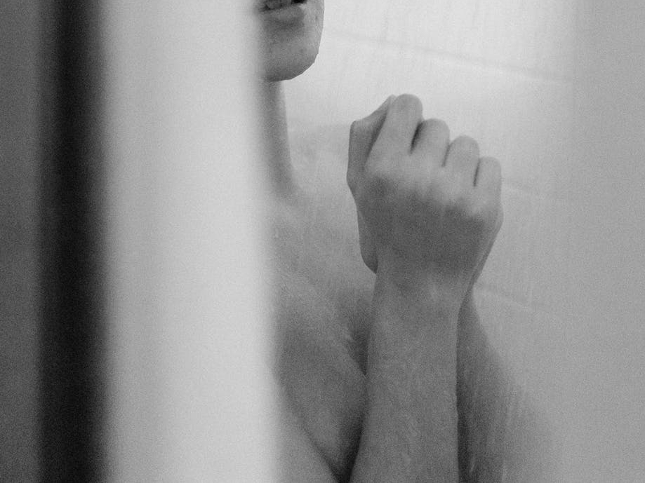 gray scale photo of woman taking bath